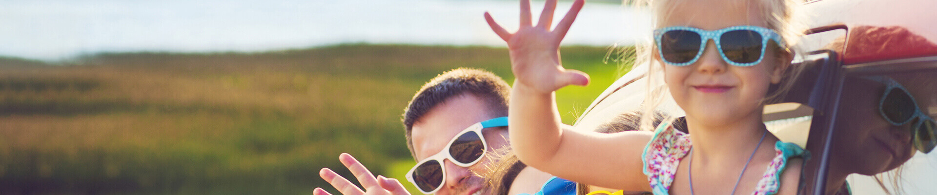 A children in sunglasses waving in the summer
