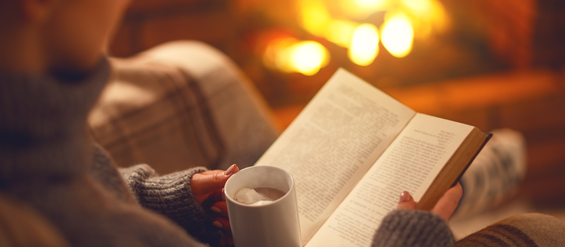 reading by fireplace