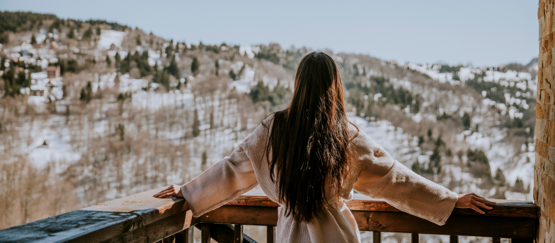 Girl on hotel balcony in hotel robe
