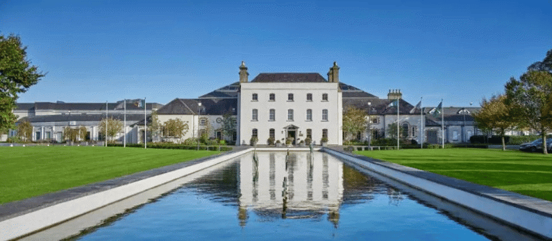Luxury Johnstown Estate hotel in Enfield, County Meath, featuring landscaped gardens and a reflecting pool, ideal for an autumn spa break in Ireland.