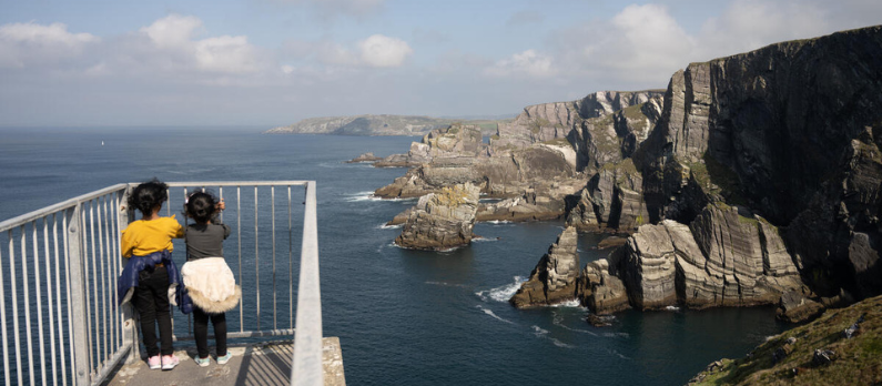 Two children looking over Mizen Head