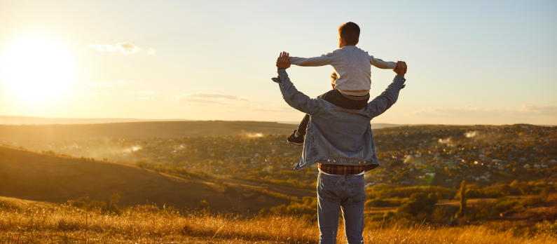 Father and son watching sunset